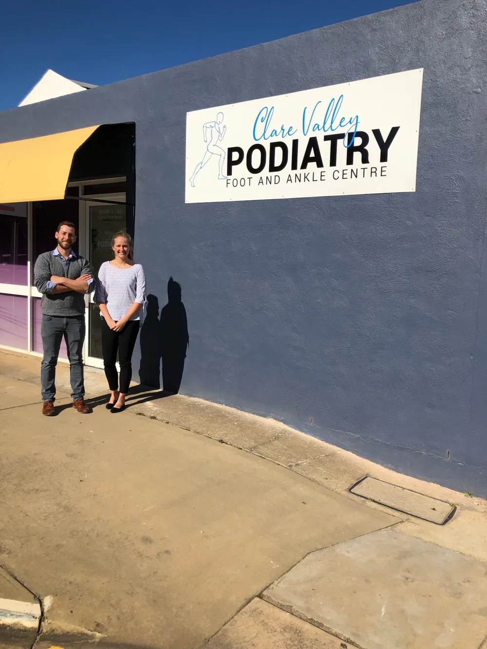 Reid Jones and Rachel standing outside the Clare Valley Podiatry shop front in Clare